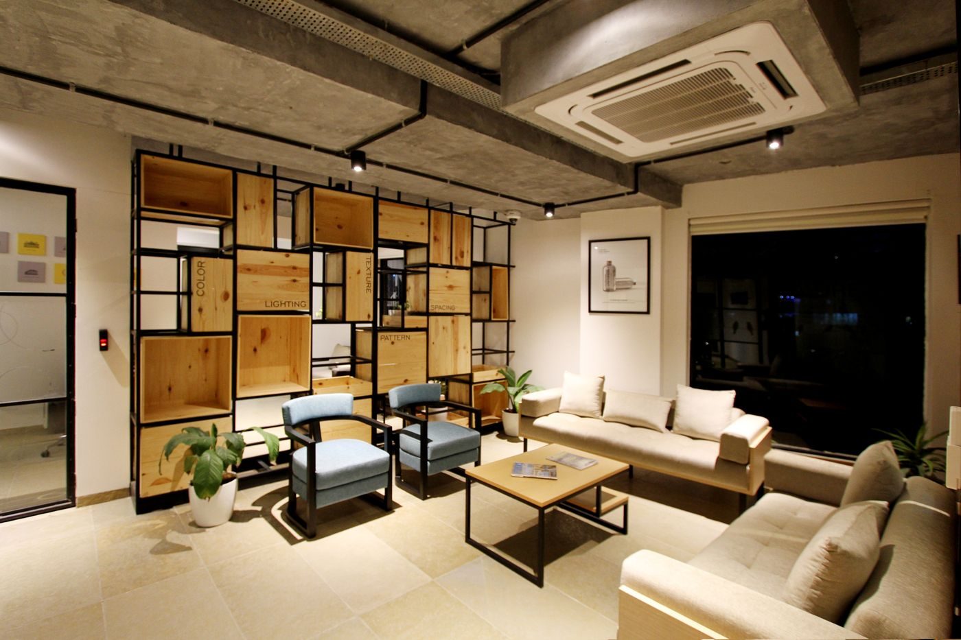 Lounge with a concealed ceiling cassette air conditioning unit set into the ceiling